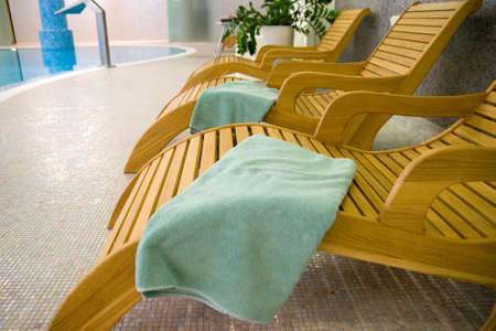 Sunbeds in the  with turquoise towel near the swimming poolの写真素材