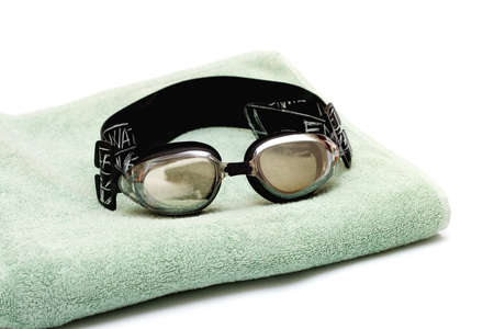 glasses for swim lay on the towel on white の写真素材