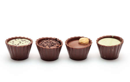 Mixed Chocolates in a row against a white background ( candy basket )の写真素材