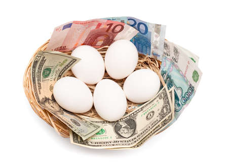 Eggs with money in basket isolated on white background. Financial concept.の写真素材