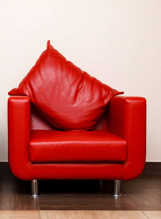 Red leather chair with pillowの写真素材
