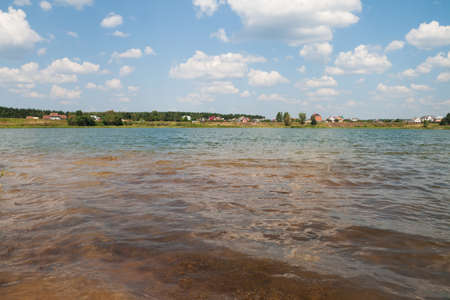 Lake amongst the woods, cloudy summer sky の写真素材