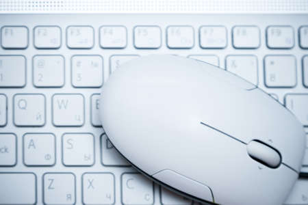 White computer mouse on  the keyboardの写真素材