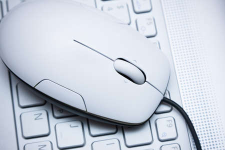 White computer mouse on  the keyboardの写真素材