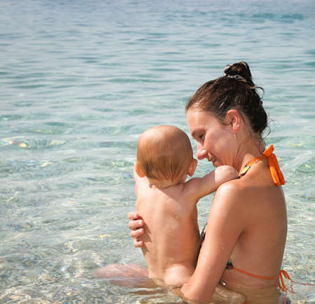 mother with baby in the sea