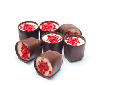 Heap of Chocolates with candied fruit against a white 