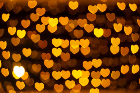 defocused golden lights in the shape of heartsの写真素材