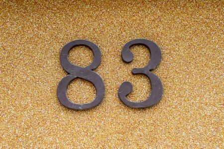 house number eighty-three on the beige wall 83.