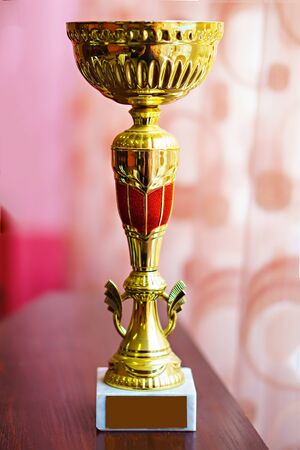 Gold Cup on wooden table.の写真素材