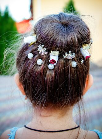 Beautiful hairstyle of a little girl. rear view.の写真素材