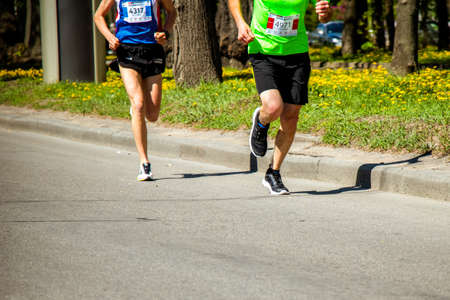 Ukraine, Vinnitsa, June 1, 2019. Khmelnitsky highway.Marathon running race people competing in fitness and healthy active lifestyle feet on roadのeditorial素材
