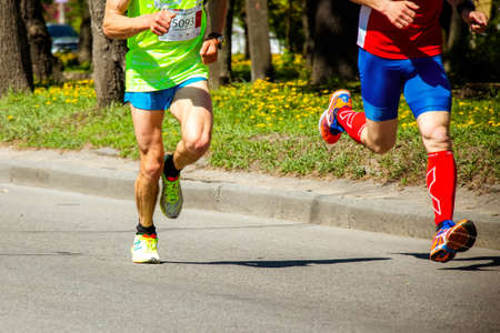 Ukraine, Vinnitsa, June 1, 2019. Khmelnitsky highway.Marathon running race people competing in fitness and healthy active lifestyle feet on roadのeditorial素材