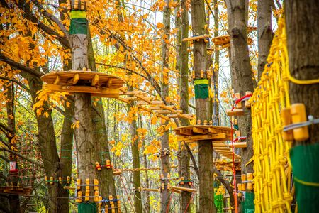 Rope Park in the fall. Recreation, entertainment. Climbing rides, zipline, rope snowboard. playing...