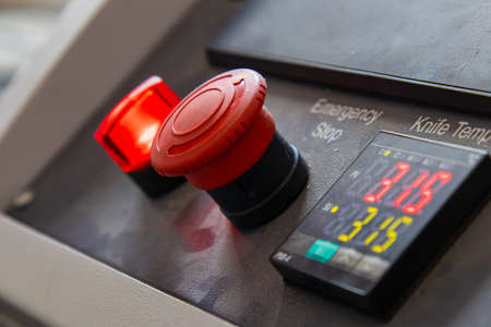 Large red button for turning the machine on and off on the Weaving Plant For The Production Of Plastic Or Polypropylene Bags.の写真素材