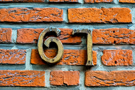 Close-up of the brick wall with the number 67 on it.