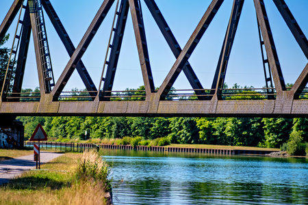 Bridge over river with sign underneath it that says "Danger keep out".の写真素材