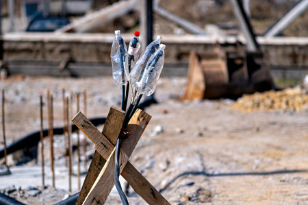 This image shows a collection of discarded items including plastic bottles and what appears to be a piece of wood or a stickの写真素材