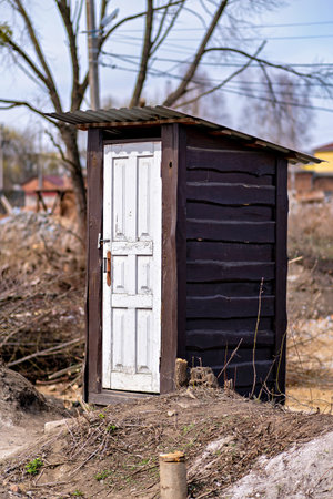 This is an image of a small old wooden structure that appears to be a shed or outhouse