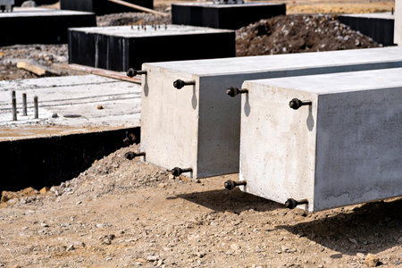 A construction site with several concrete blocks or slabs in various stages of completionの写真素材