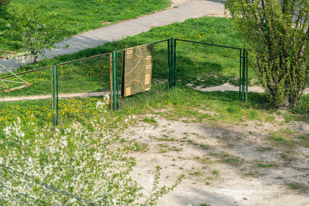 A green metal fence with a sign attached to itの写真素材