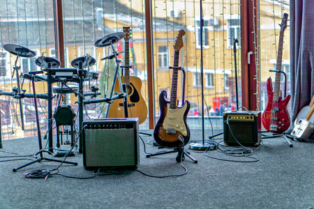 This image shows a collection of musical instruments including guitars a bass guitar and a drum setの写真素材