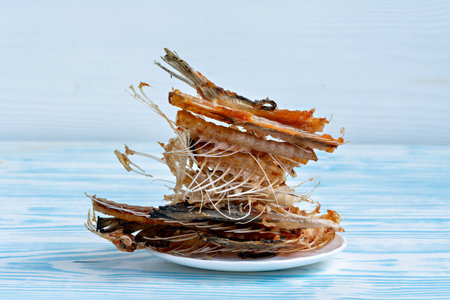 This image shows a plate with a pile of what appears to be fried fish or seafood.の写真素材
