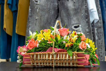 This is an image of a beautifully arranged floral bouquet in a woven basketの写真素材