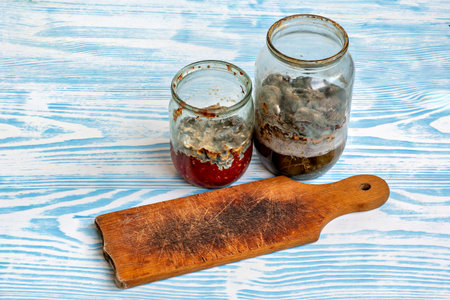 This image shows three jars with different contents on a table with a blue and white patterned surfaceの写真素材