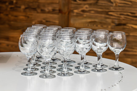 This image shows a collection of wine glasses arranged neatly on a white surface