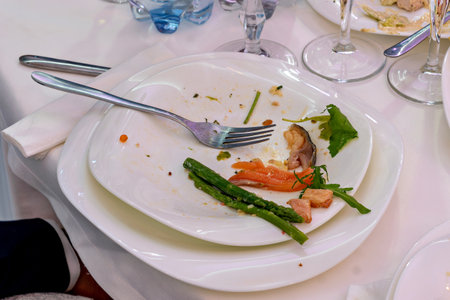 A plate with a fork and a few pieces of food on itの写真素材