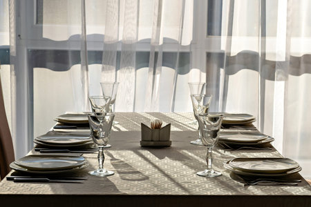 A table set for a formal dinner with plates and glasses on it.