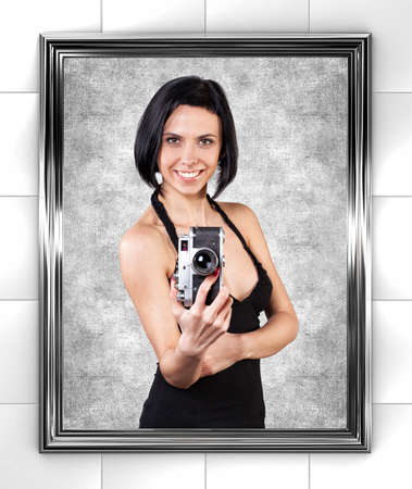 Girl with camera is photographed before a mirror