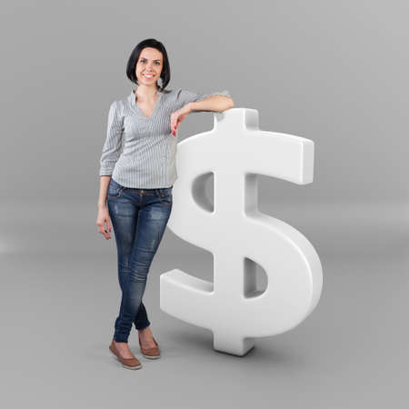 Beautiful girl stand with a big dollar symbolの写真素材