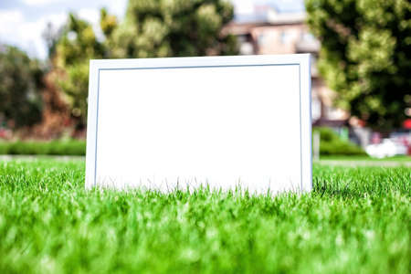 Photo of a announcement board on a green grassの写真素材