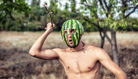 Photo of the young soldier with a water-melon on a headの写真素材