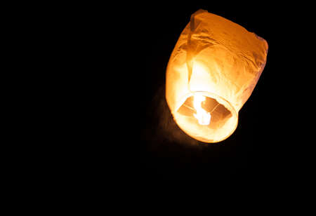 Photo of a burning big heavenly lantern at nightの写真素材