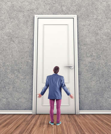 Man before a big door in fear of the unknownの写真素材
