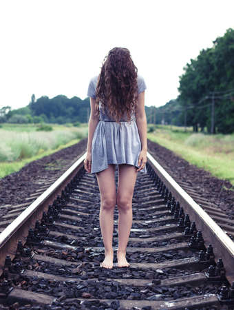 The beautiful girl stand on the railwayの写真素材