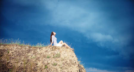 the young girl at mountain topの写真素材