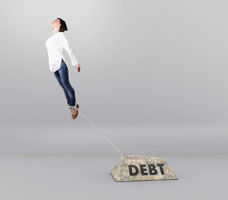 Chain with a heavy cargo on the legs of a girlの写真素材