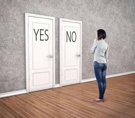 Girl before a white doors in fear of the unknownの写真素材