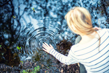 The young girl does waves on waterの写真素材