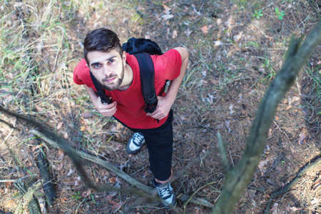 The young boy with a backpack stand under a treeの写真素材