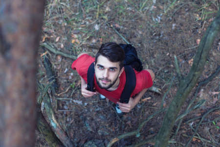 The young boy with a backpack stand under a treeの写真素材