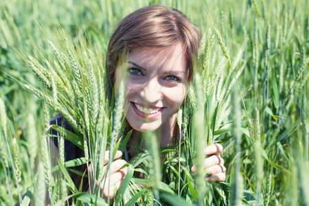 The beautiful girl is on a wheaten fieldの写真素材