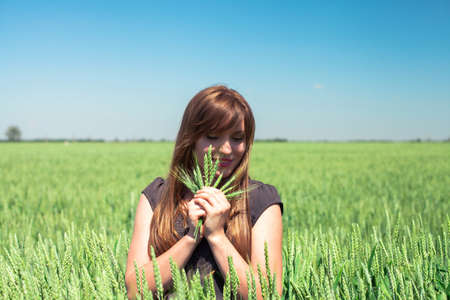 The beautiful girl is on a wheaten fieldの写真素材