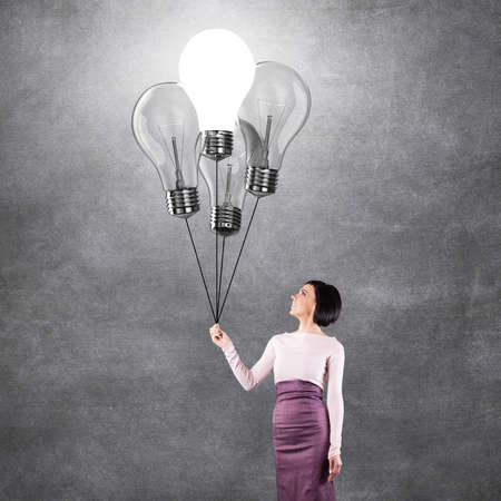 Girl with lightbulbs in the form of balloonsの写真素材