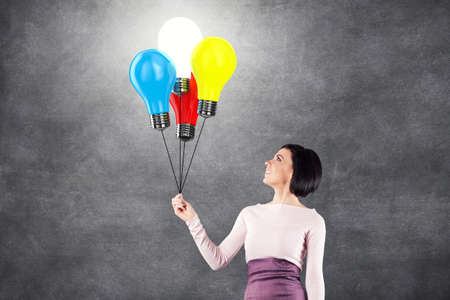 Girl with lightbulbs in the form of balloonsの写真素材
