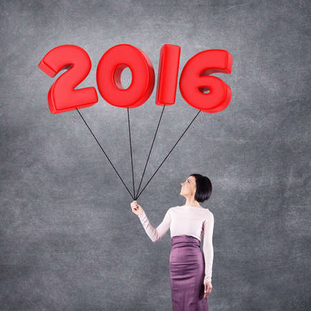 Girl with 2016 date in the form of balloons