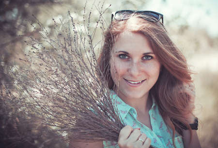 Beautiful girl with a flowers bouquet  in handsの写真素材